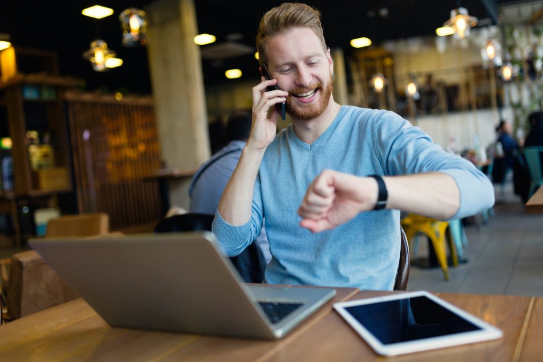 young-man-having-phone-call-in-coffee-shop.jpg